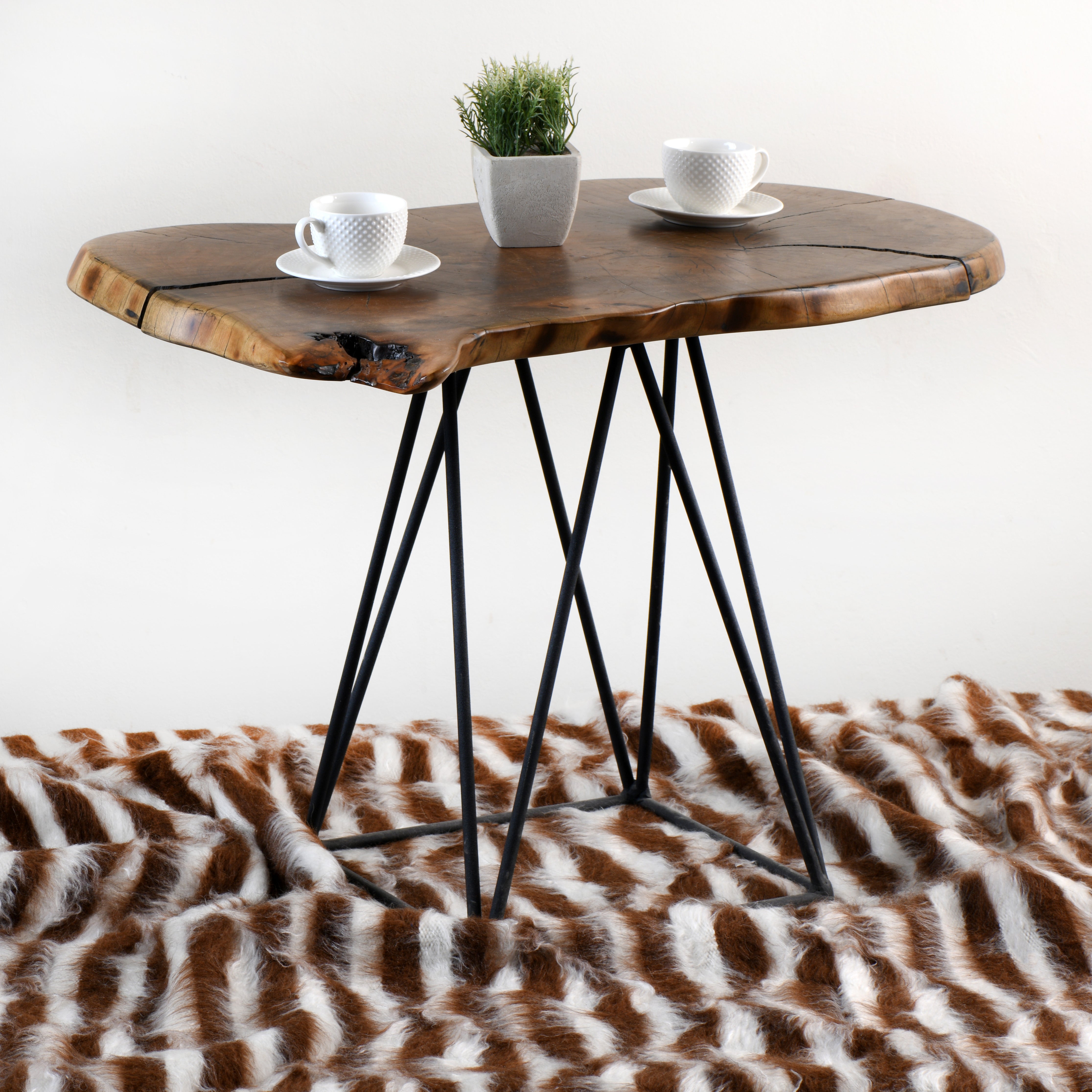 Agate mohair rug with brown and cream stripe pattern elegantly displayed under a rustic wooden coffee table, showcasing stylish home decor and luxury craftsmanship