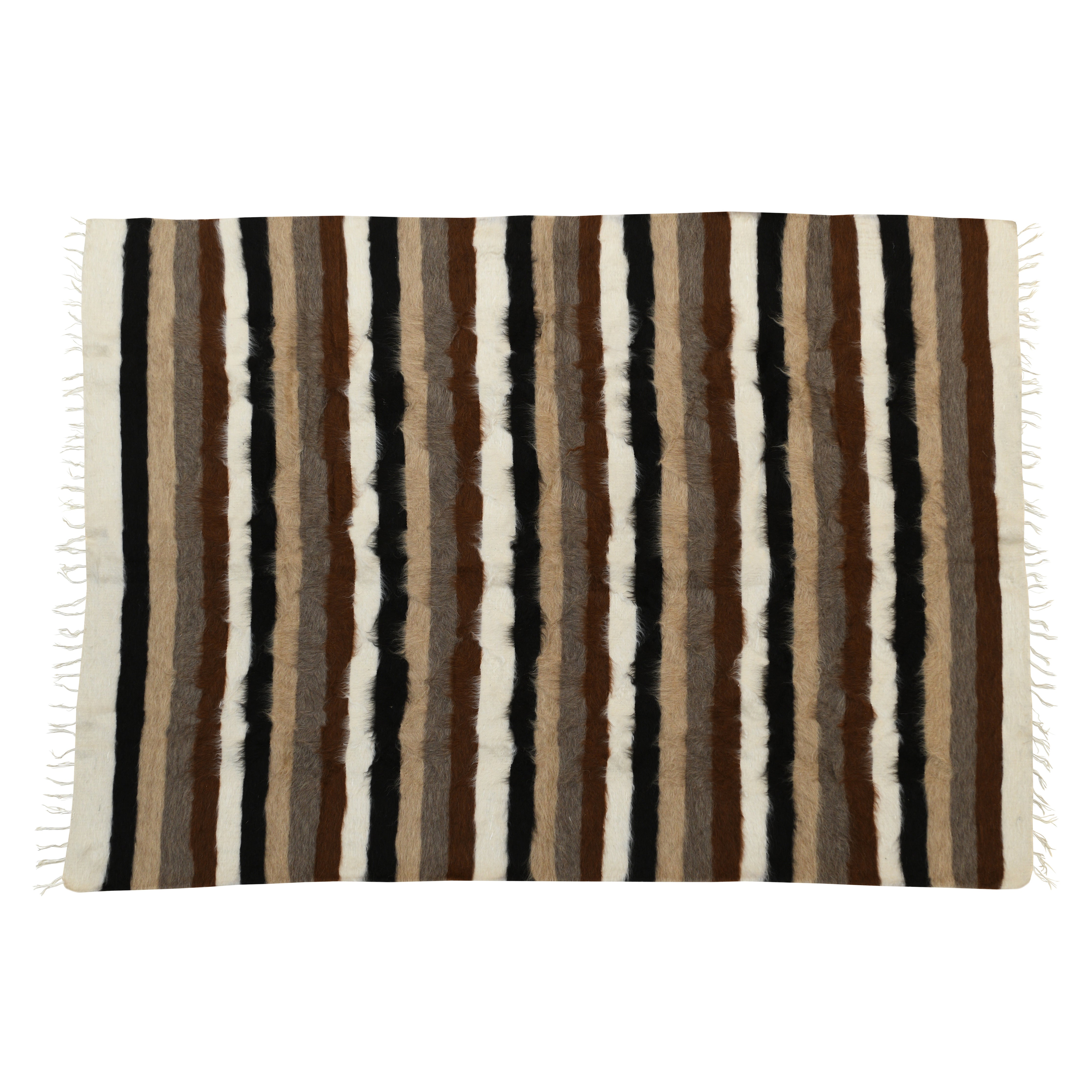 The GaiaPhos handcrafted rug made from 100% organic natural mohair, featuring earthy brown, black, and white stripes. This luxurious rug reflects the balance between earth and light, inspired by an ancient Greek legend, and is crafted using traditional techniques passed down through generations.